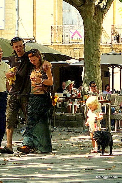 Families and pets stroll happily along.