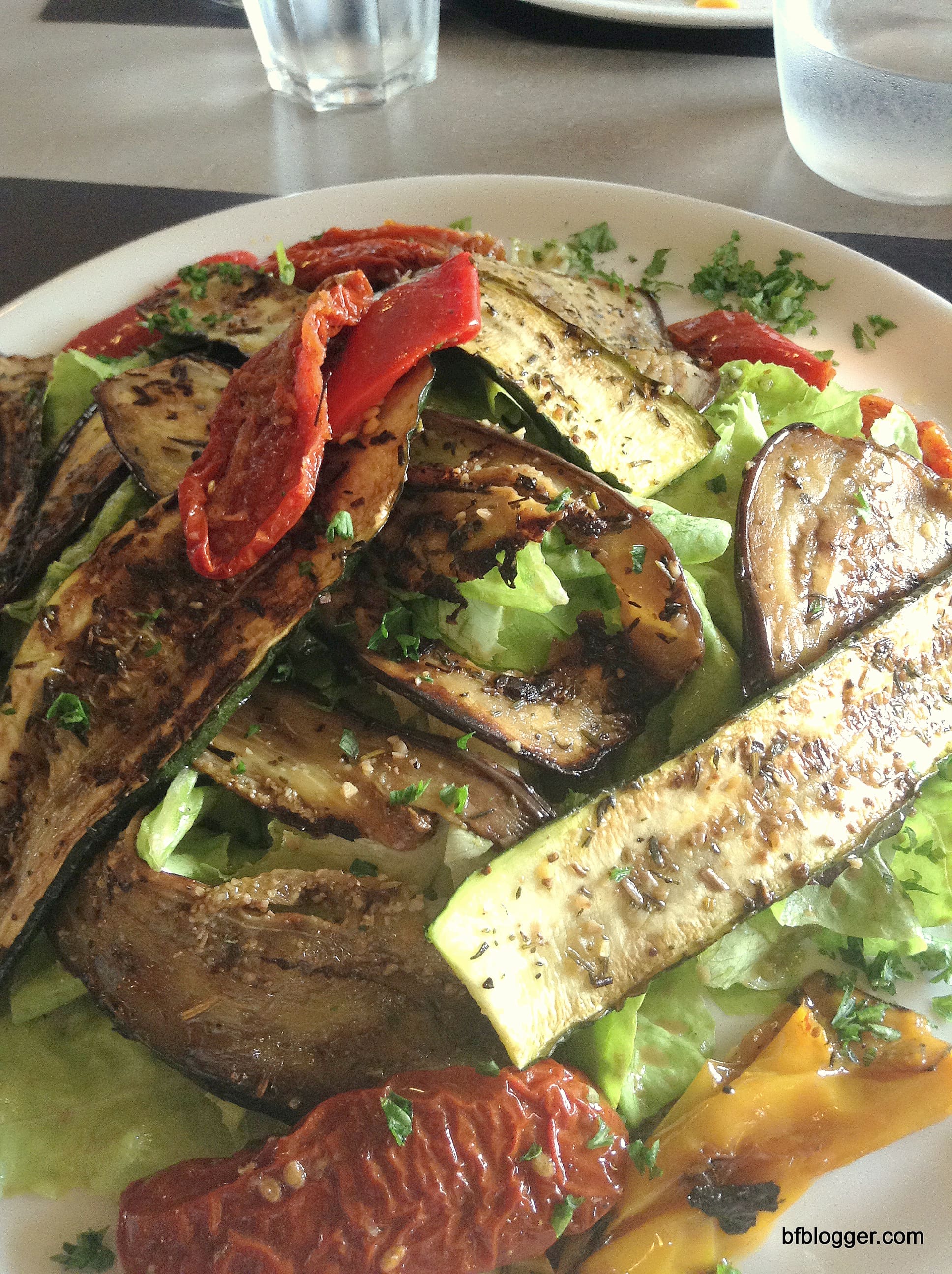 Roasted aubergine and peppers on fresh greens