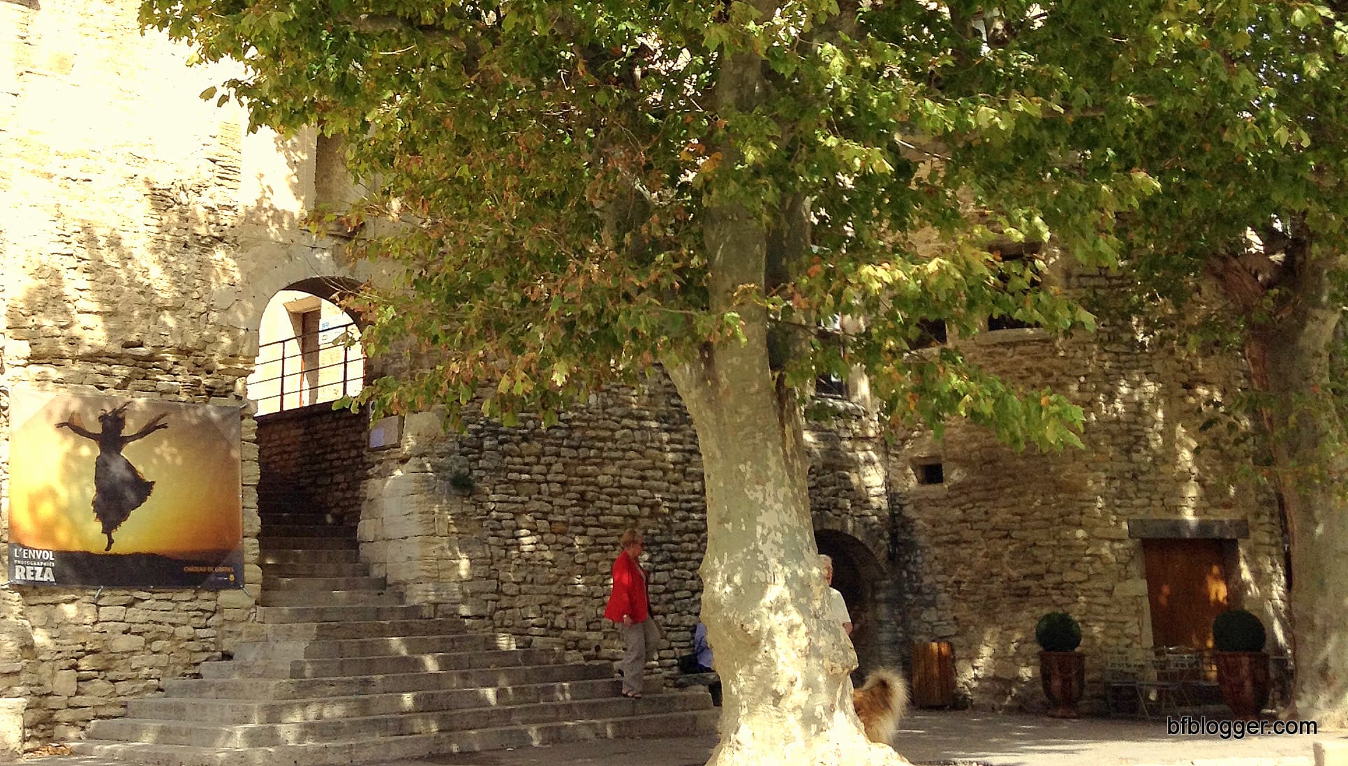 Public gathering places with ancient shade trees and stone arches