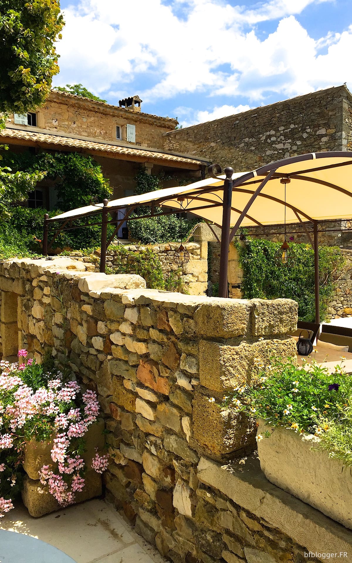 Outdoor eating area around the pool at Mas d'Augustine